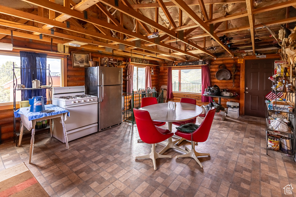 Dining space featuring log walls