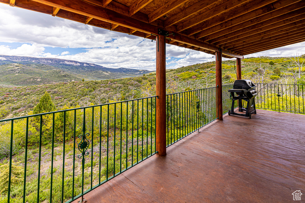 Balcony featuring a mountain view and a grill