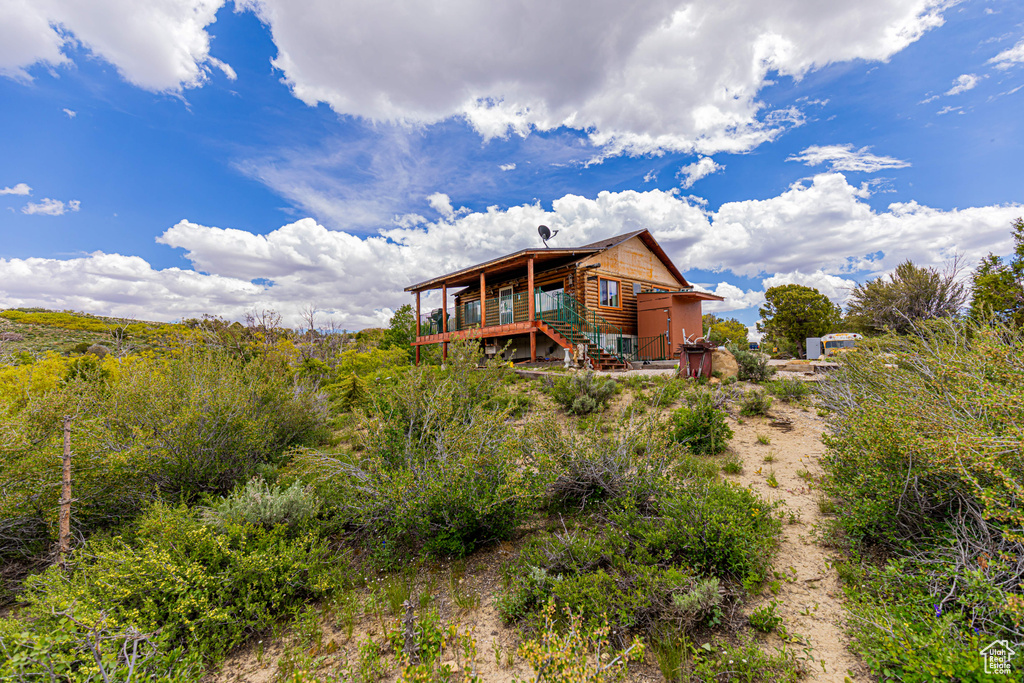 Back of house featuring a wooden deck