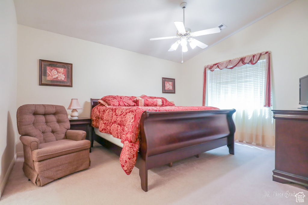 Bedroom featuring carpet flooring, lofted ceiling, and ceiling fan