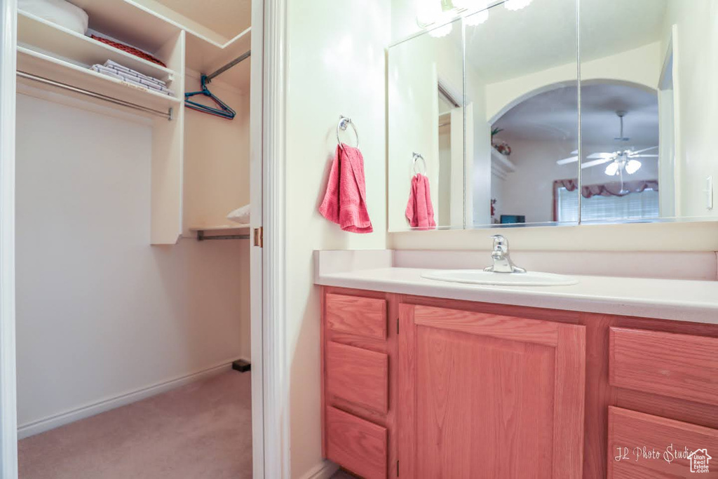 Bathroom featuring vanity and ceiling fan