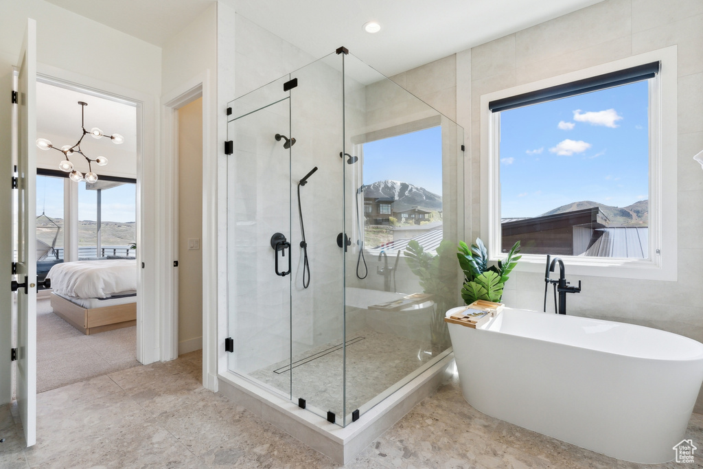 Bathroom featuring tile walls, tile flooring, and plenty of natural light