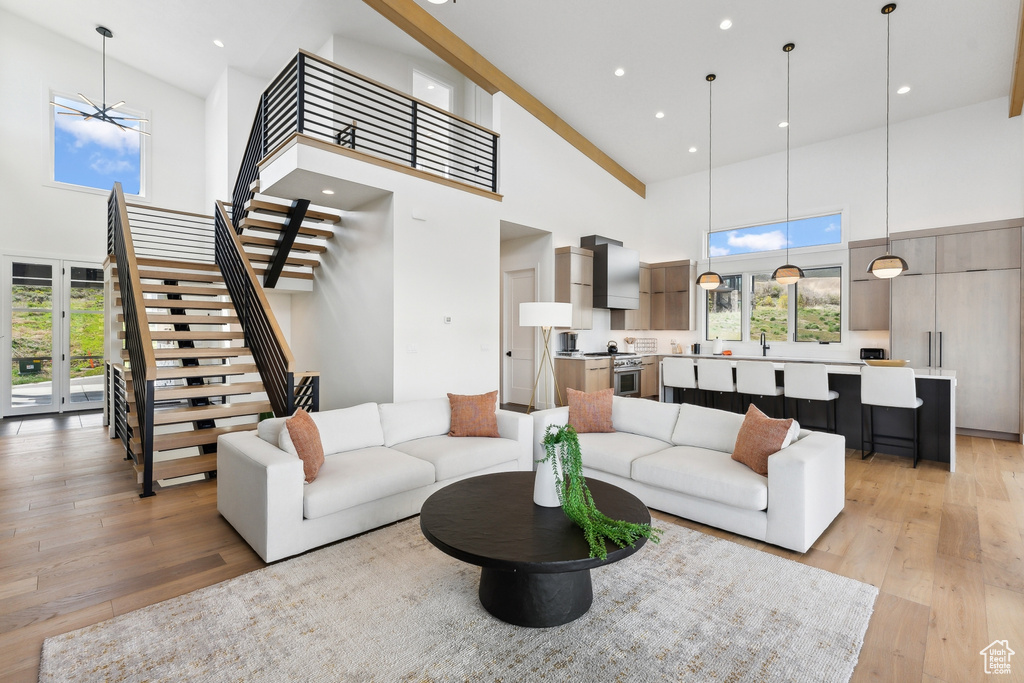 Living room featuring high vaulted ceiling and light wood-type flooring