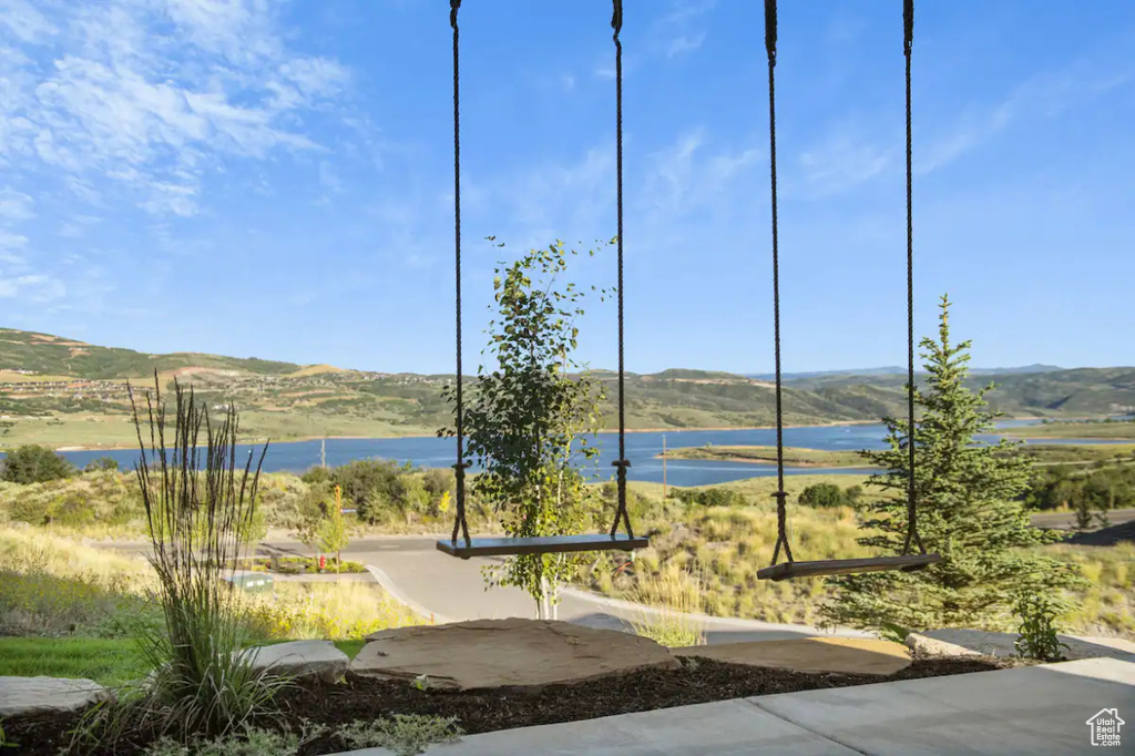 Exterior space with a water and mountain view