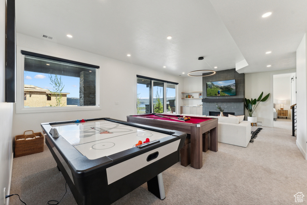 Playroom featuring light carpet, a fireplace, and pool table