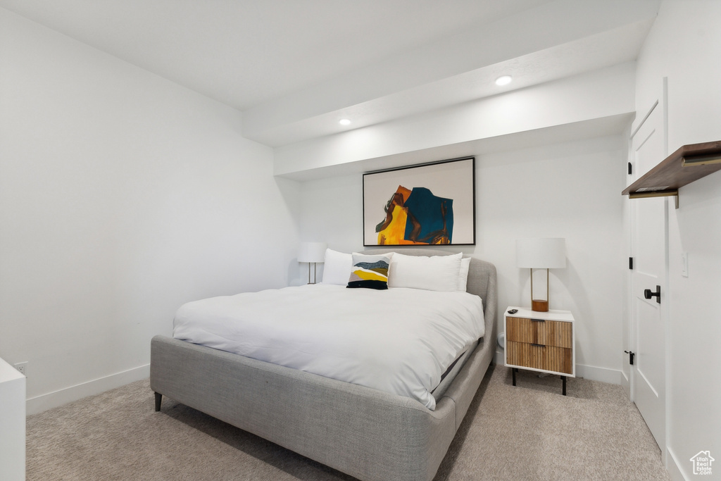 Bedroom with light colored carpet