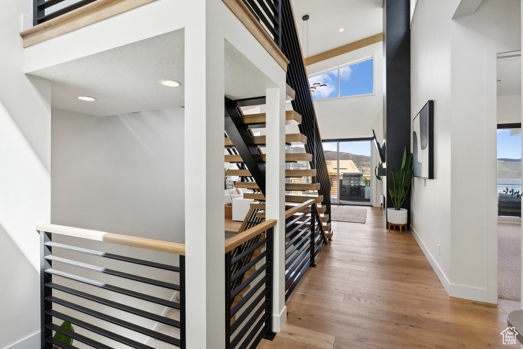 Interior space featuring a high ceiling and light wood-type flooring