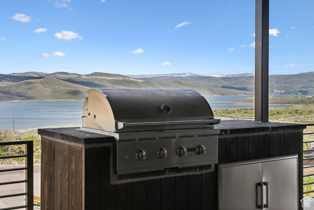 Exterior space with exterior kitchen and a water and mountain view