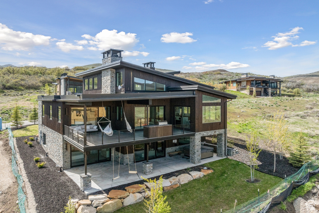 Back of property featuring a patio area and a balcony