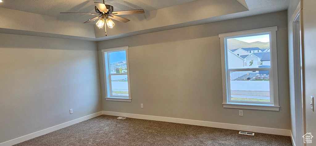 Unfurnished room with ceiling fan and carpet