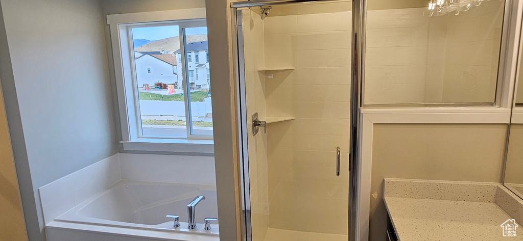 Bathroom with vanity, plus walk in shower, and a wealth of natural light