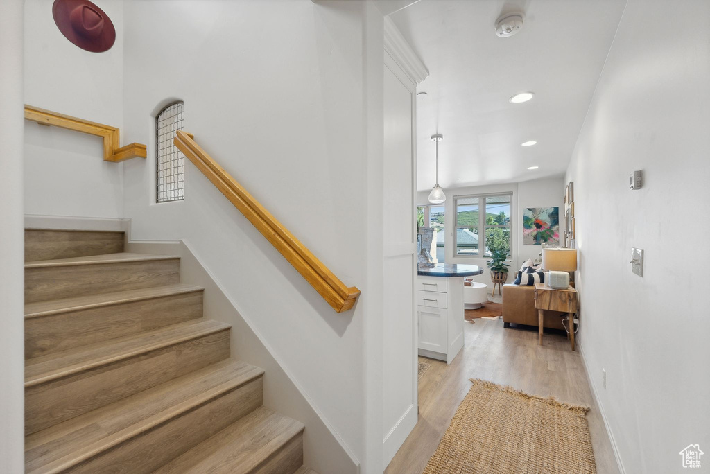 Staircase featuring wood-type flooring