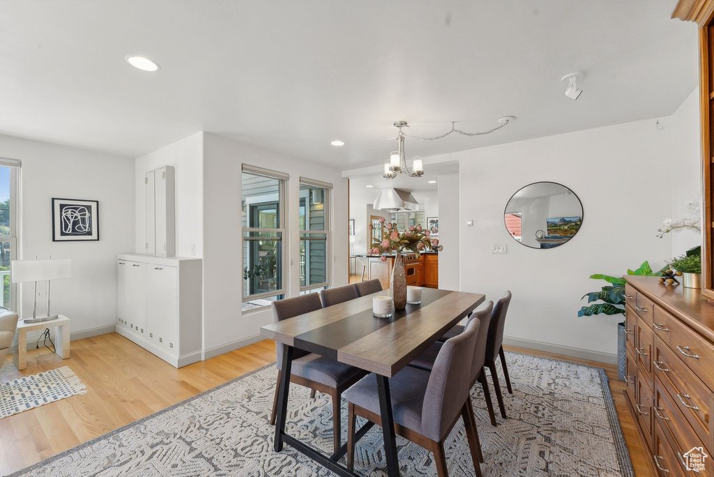 Dining area featuring an inviting chandelier and light hardwood / wood-style flooring