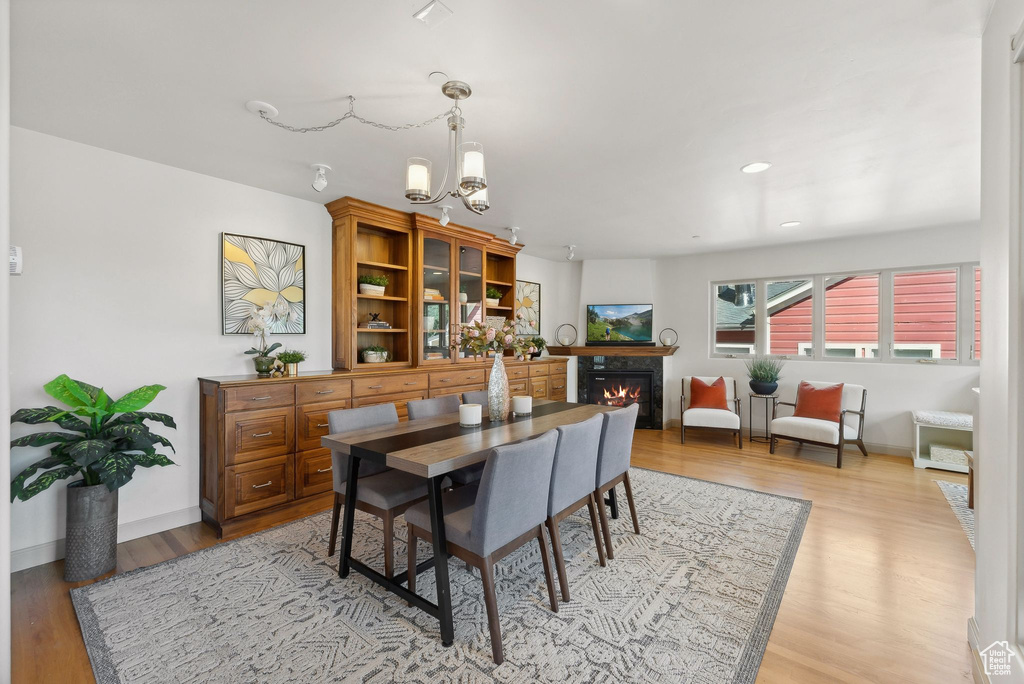 Dining space featuring a chandelier and light hardwood / wood-style floors