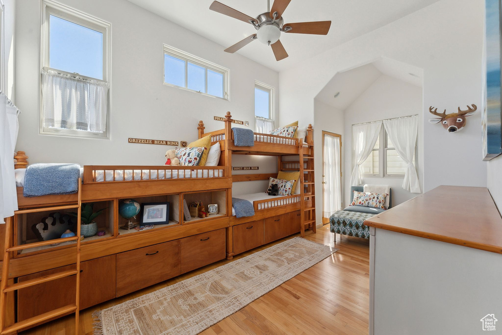 Bedroom featuring light wood-type flooring, ceiling fan, and vaulted ceiling