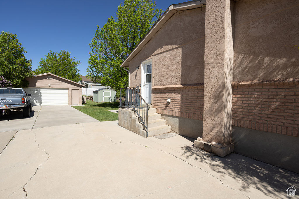 View of side of property featuring an outdoor structure and a garage