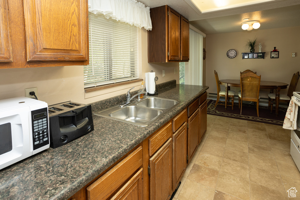 Kitchen with sink and light tile floors