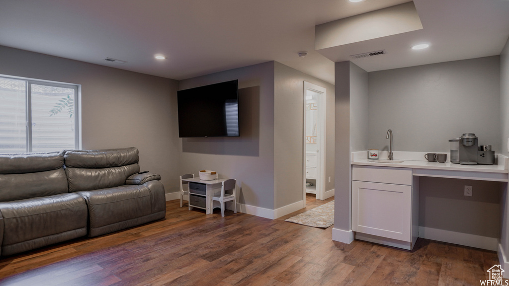 Living room with hardwood / wood-style floors and sink