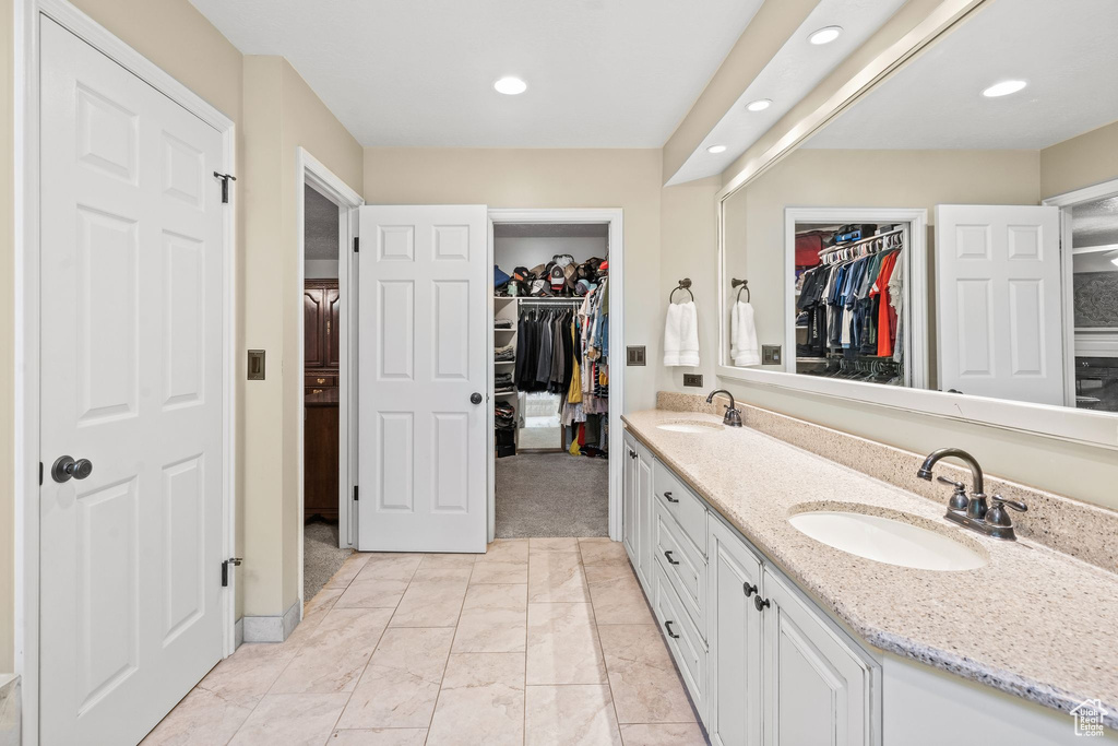 Bathroom with double sink vanity and tile floors