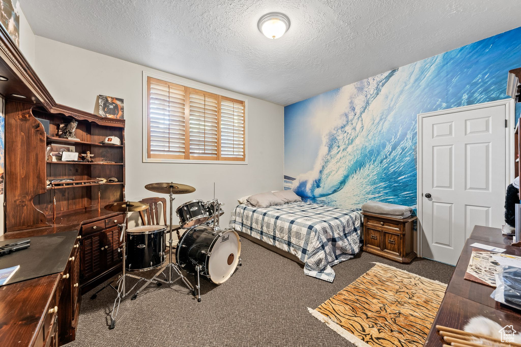 Carpeted bedroom with a textured ceiling