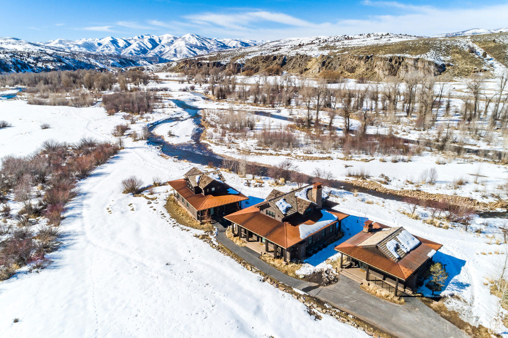 Snowy aerial view featuring a mountain view