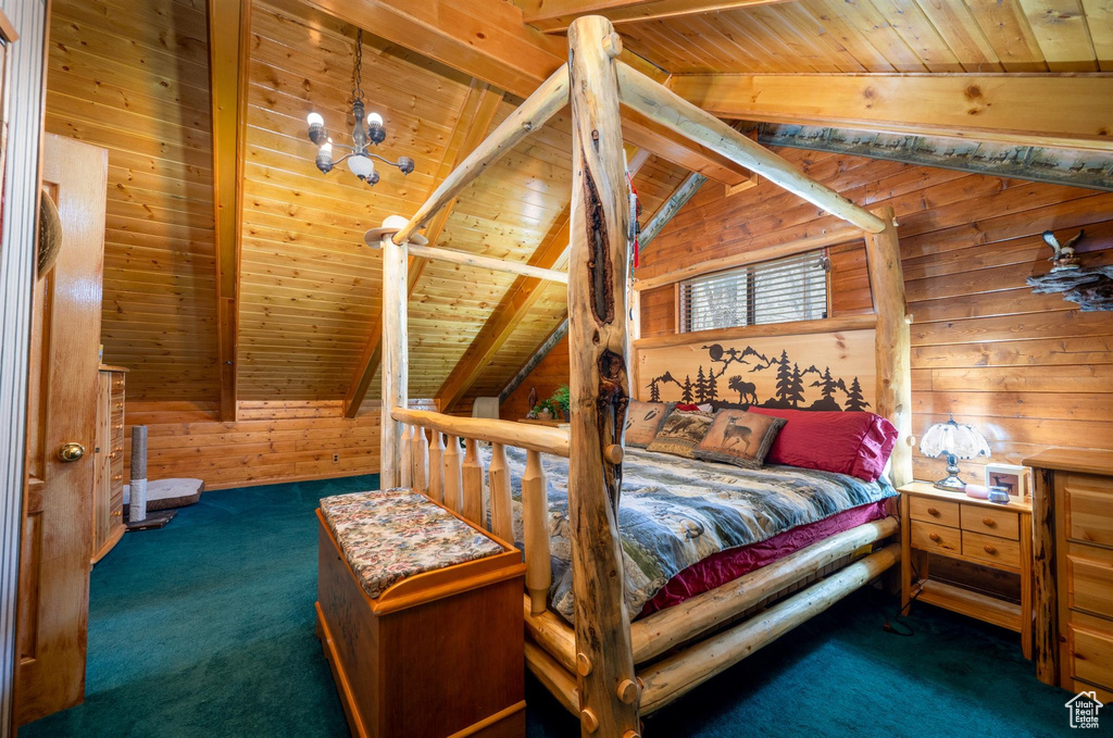 Carpeted bedroom with wooden ceiling, vaulted ceiling with beams, and wooden walls