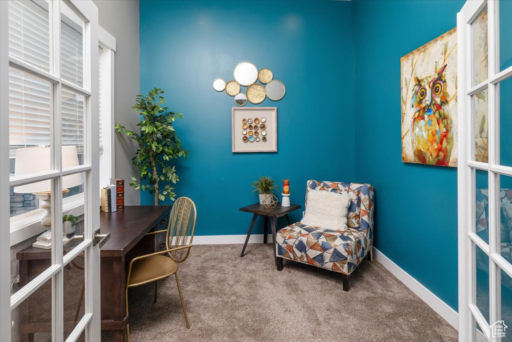 Carpeted office space with french doors