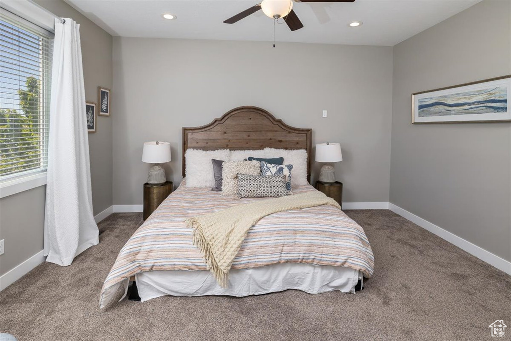 Bedroom featuring dark colored carpet and ceiling fan