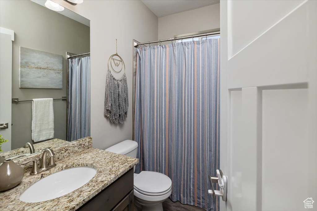 Bathroom featuring oversized vanity and toilet