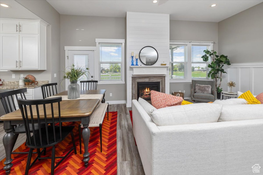 Living room with a healthy amount of sunlight and dark hardwood / wood-style flooring