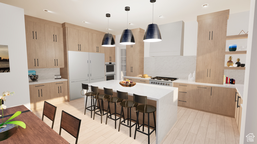 Kitchen with light hardwood / wood-style flooring, decorative light fixtures, light brown cabinetry, a kitchen island, and backsplash