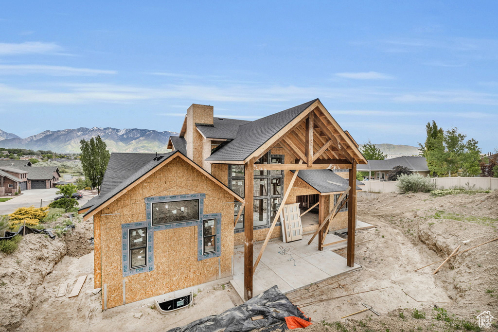 Unfinished property featuring a patio and a mountain view