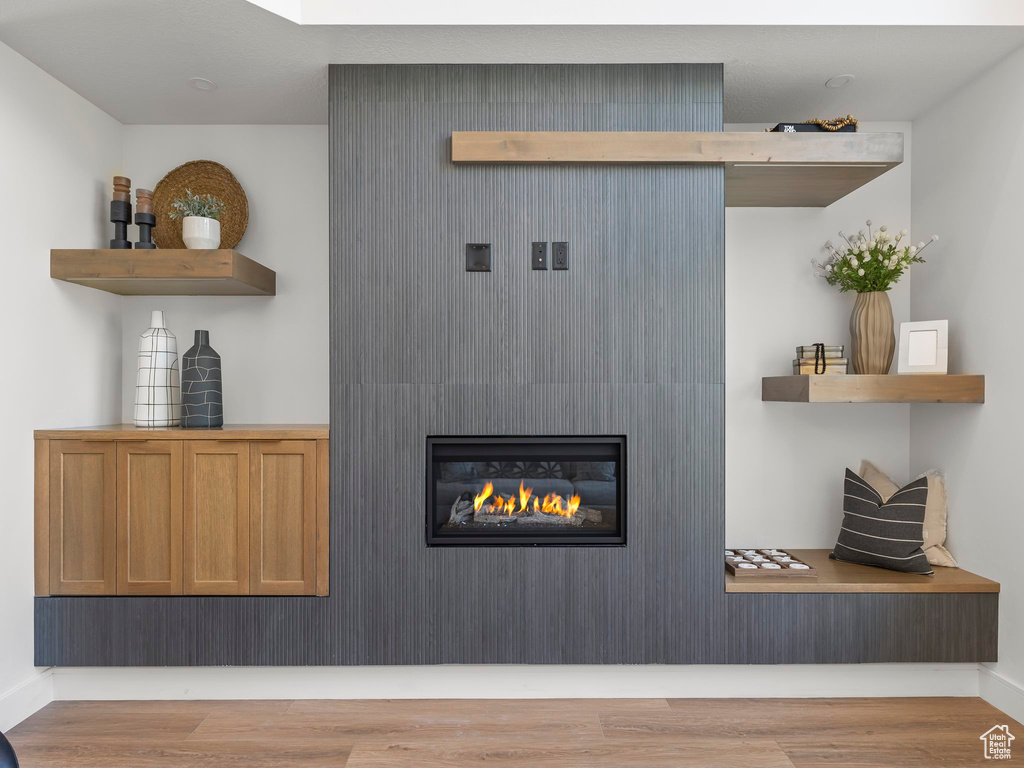 Interior space featuring wood-type flooring and a large fireplace