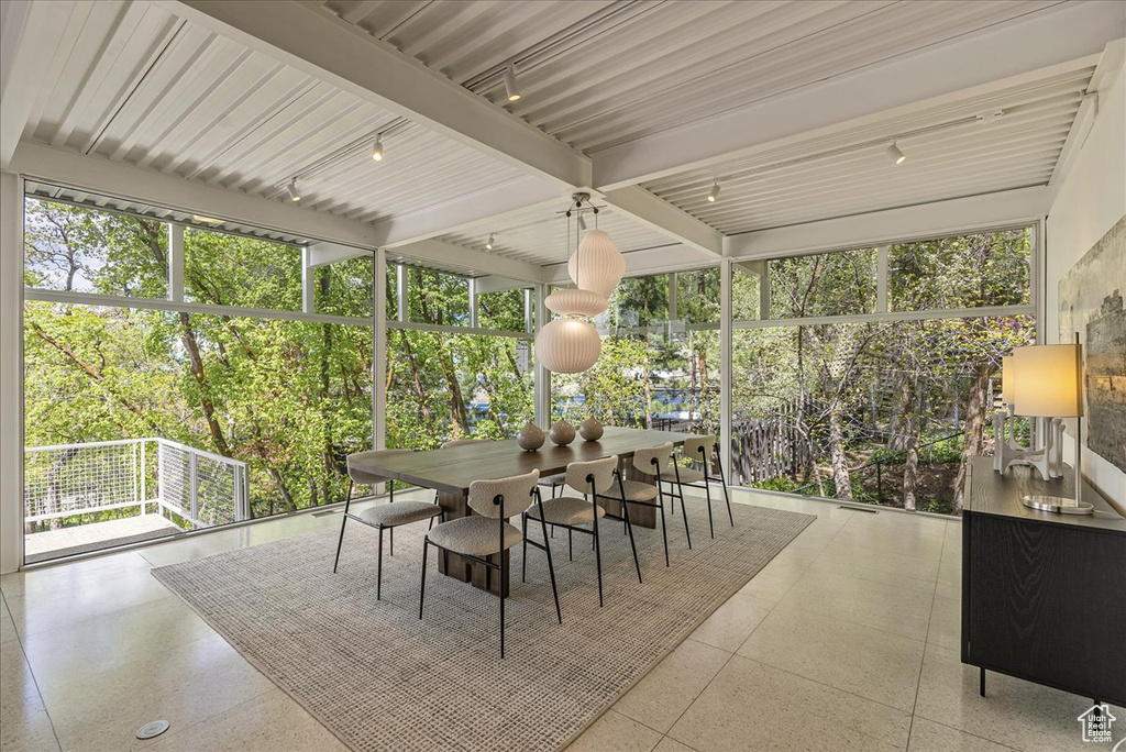 Sunroom featuring beamed ceiling