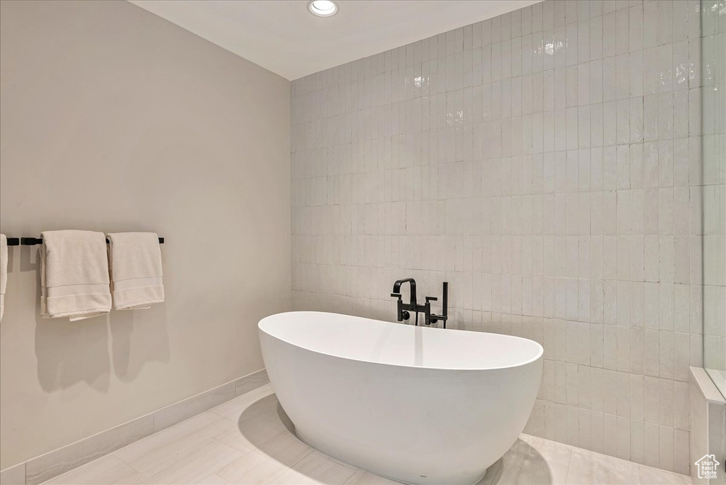 Bathroom with tile walls and tile floors