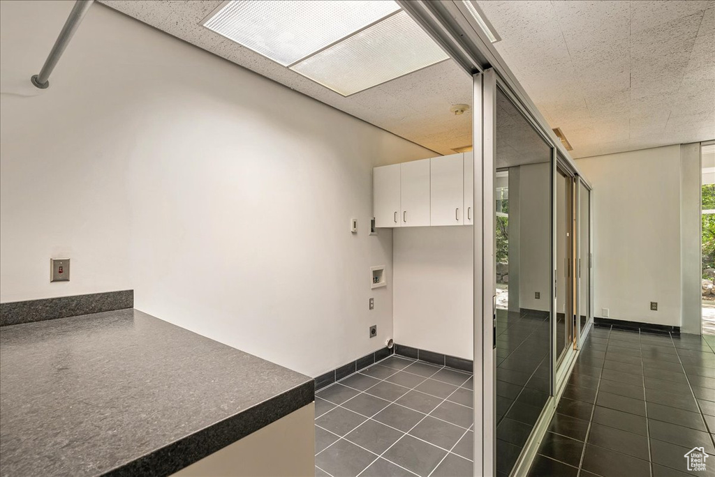 Interior space featuring white cabinets and tile floors