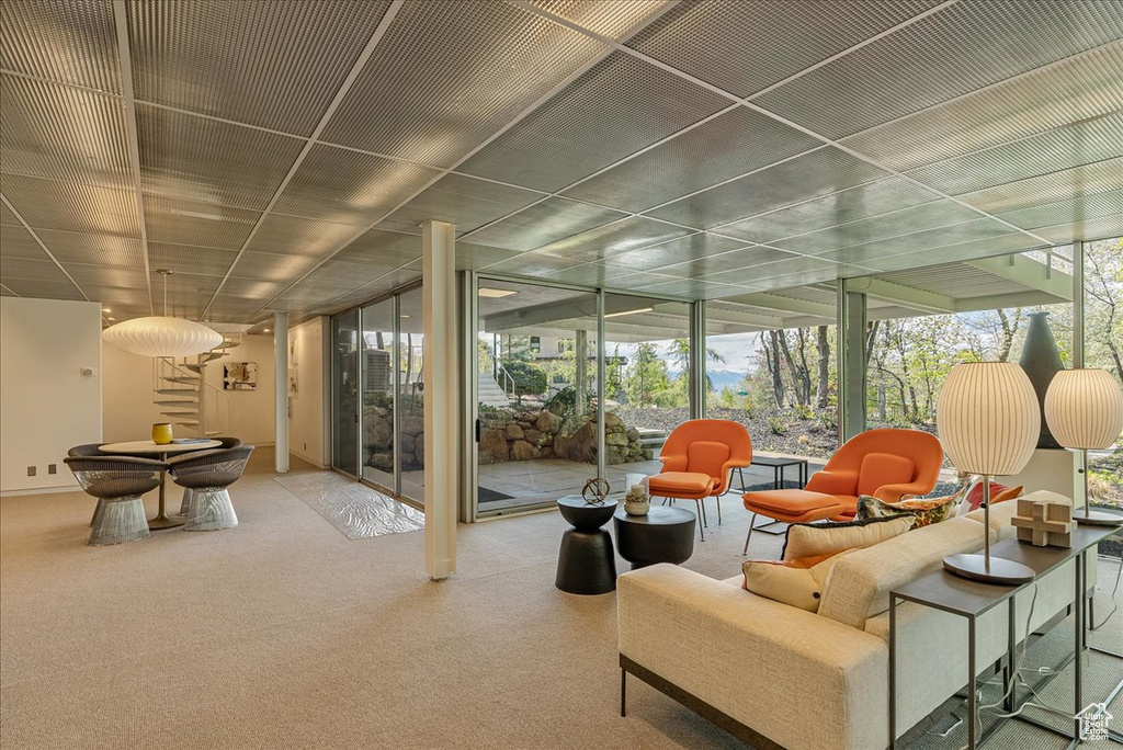 Interior space with floor to ceiling windows and carpet flooring