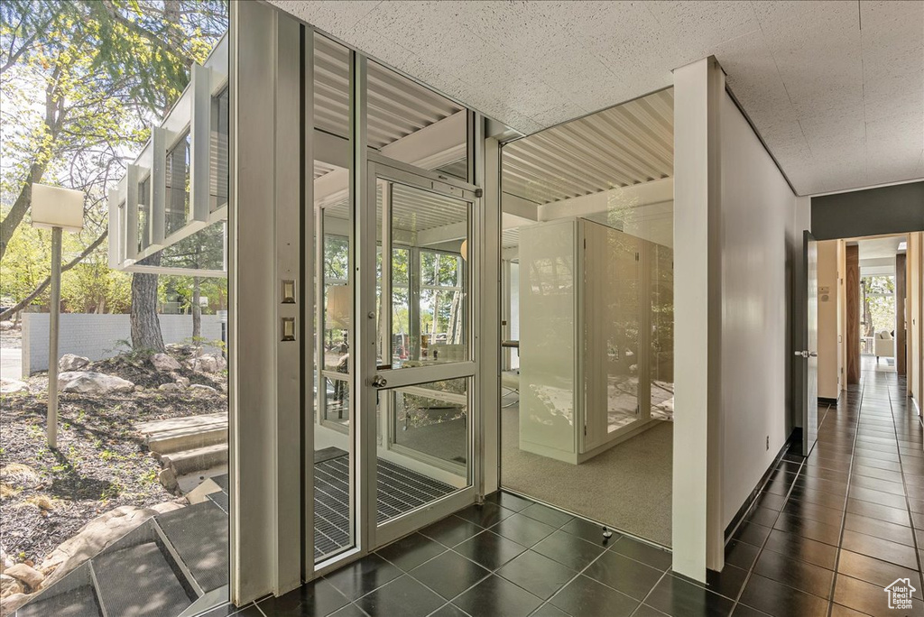 Entryway featuring dark tile flooring