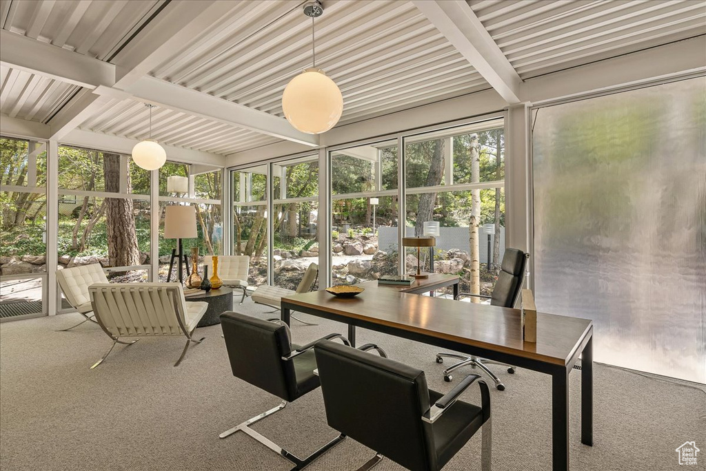 Sunroom / solarium featuring beam ceiling