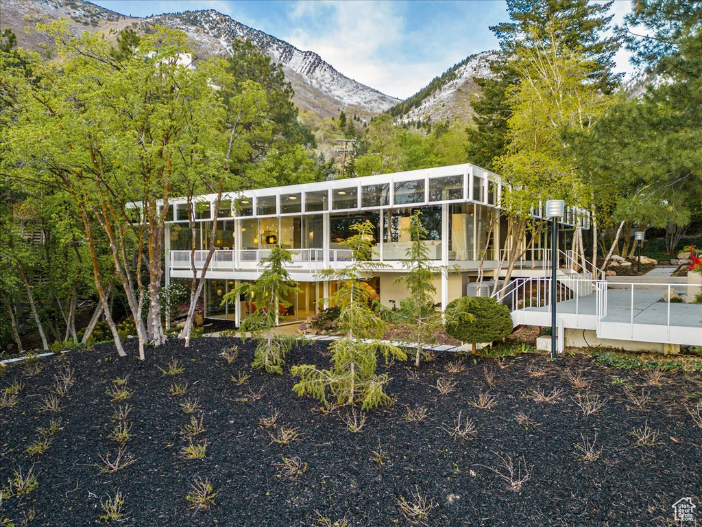 Rear view of property featuring a deck with mountain view