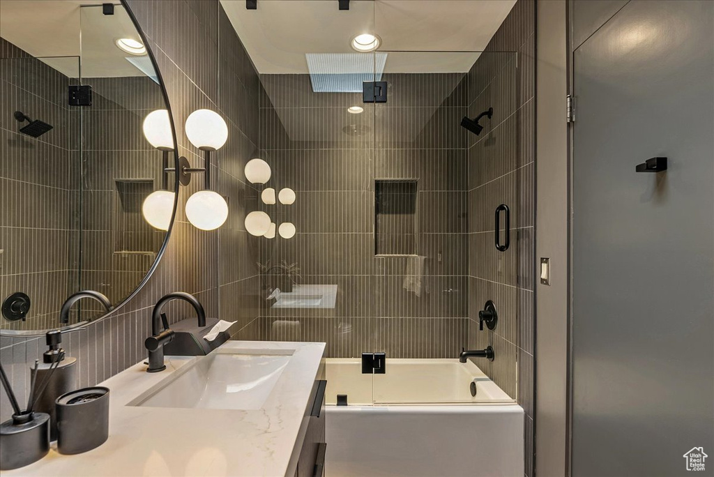 Bathroom with shower / bath combination with glass door and large vanity