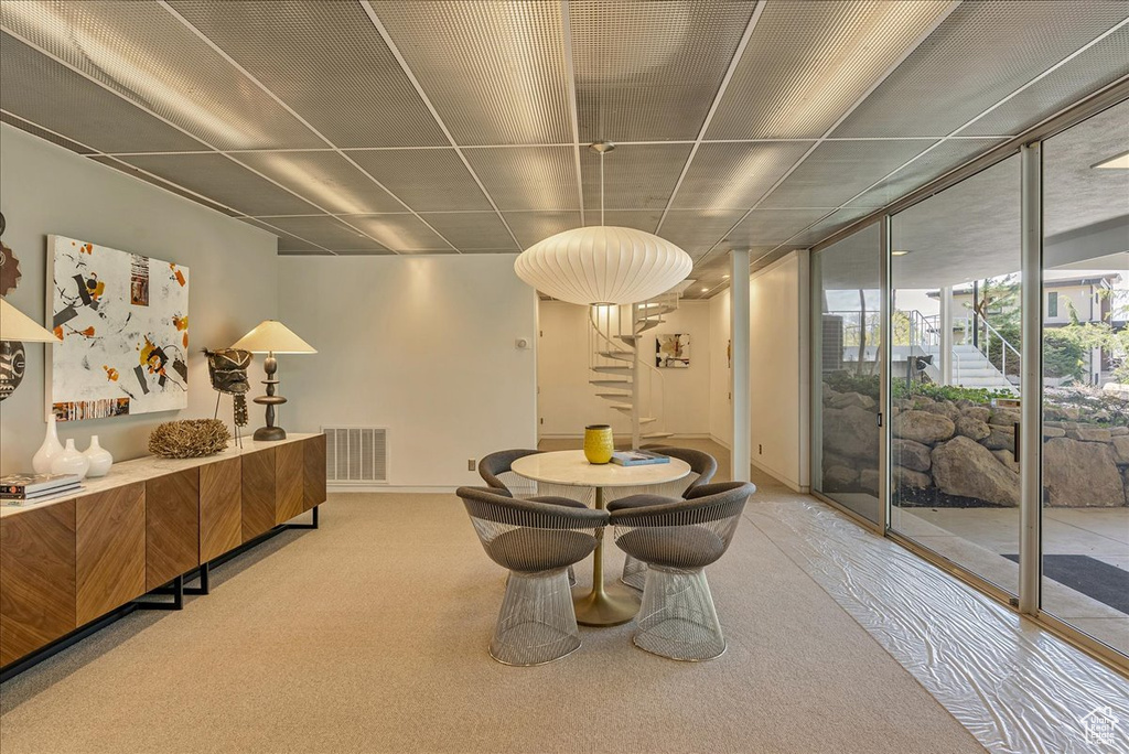 Dining space featuring carpet flooring and expansive windows