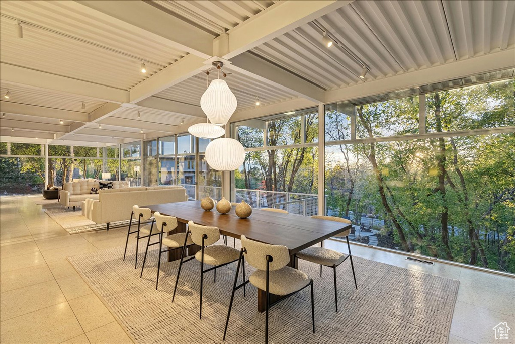 Sunroom / solarium featuring beamed ceiling