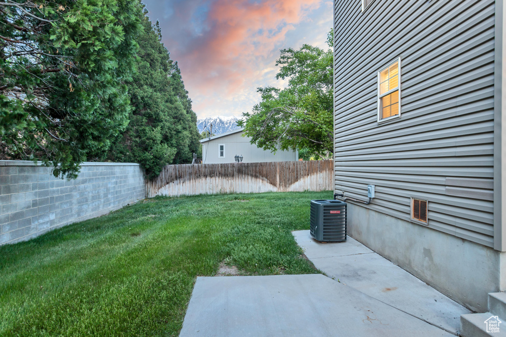 Yard at dusk with central AC