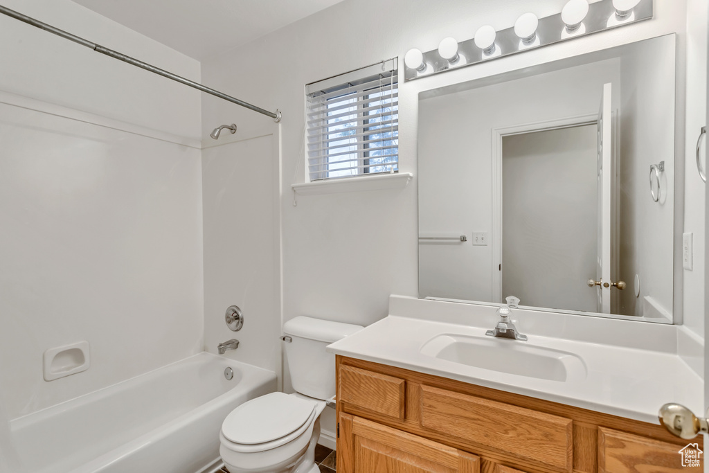 Full bathroom featuring bathing tub / shower combination, vanity, and toilet