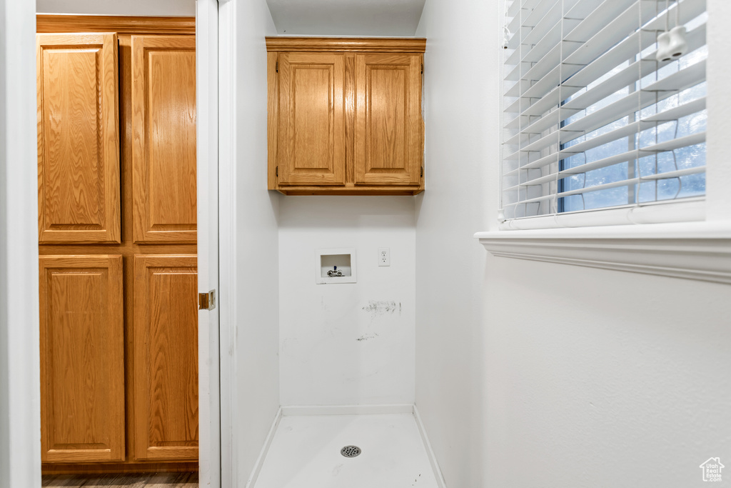 Washroom with cabinets and washer hookup