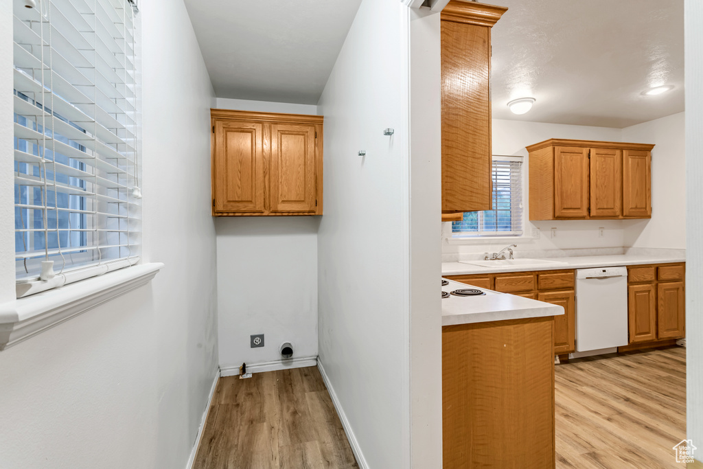 Washroom featuring sink and light hardwood / wood-style flooring