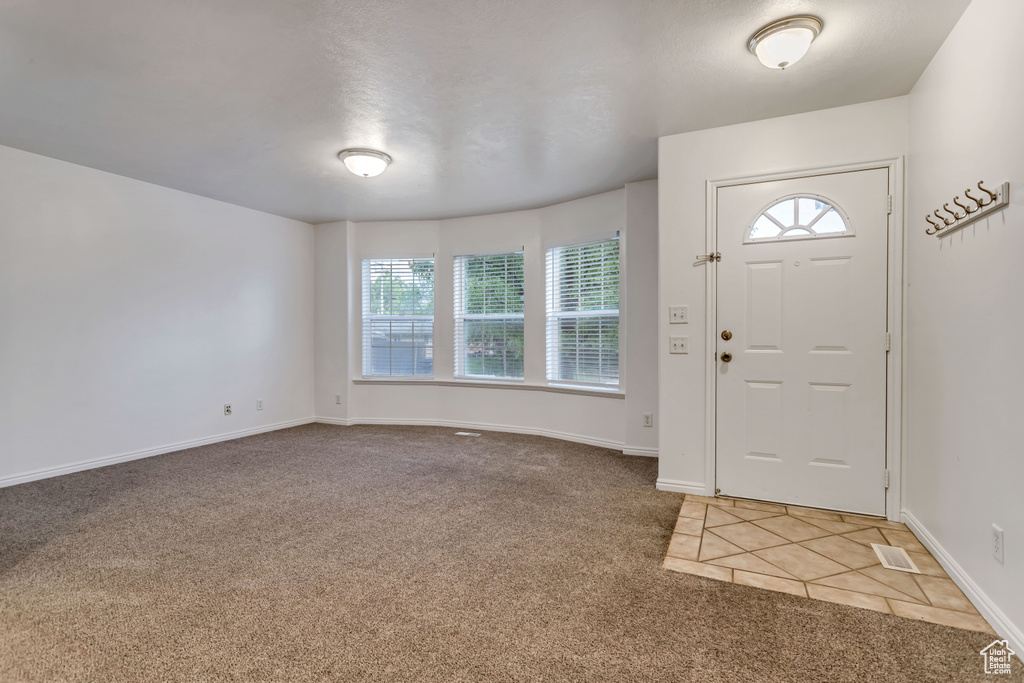 Entrance foyer with carpet flooring