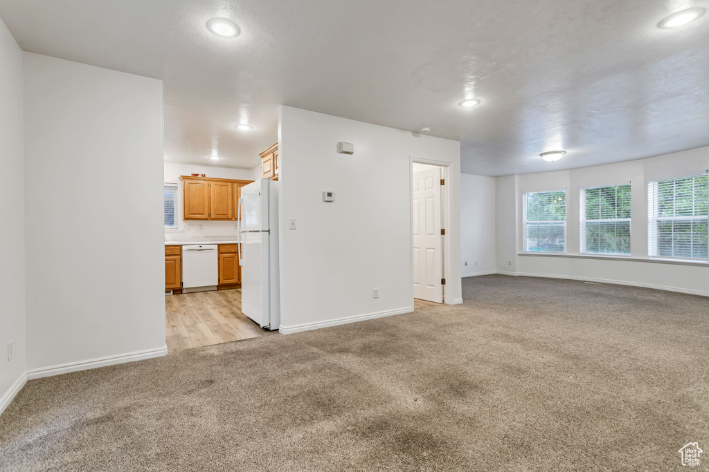 Unfurnished living room with light colored carpet