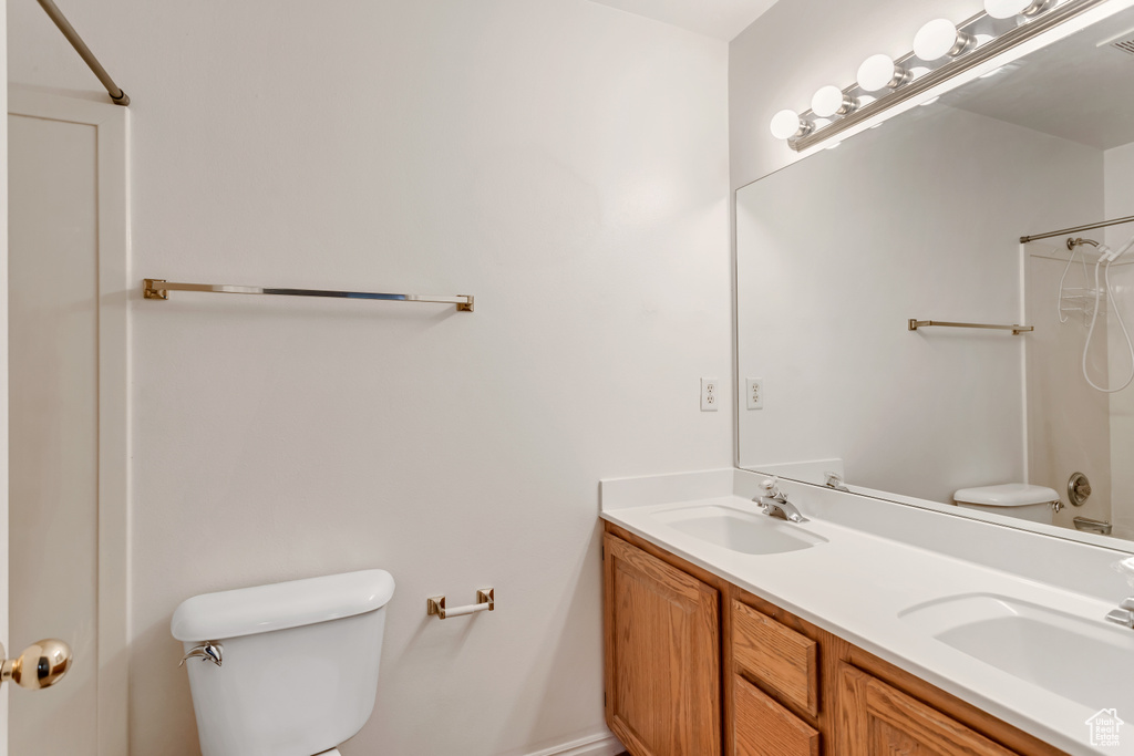 Bathroom with double sink vanity and toilet